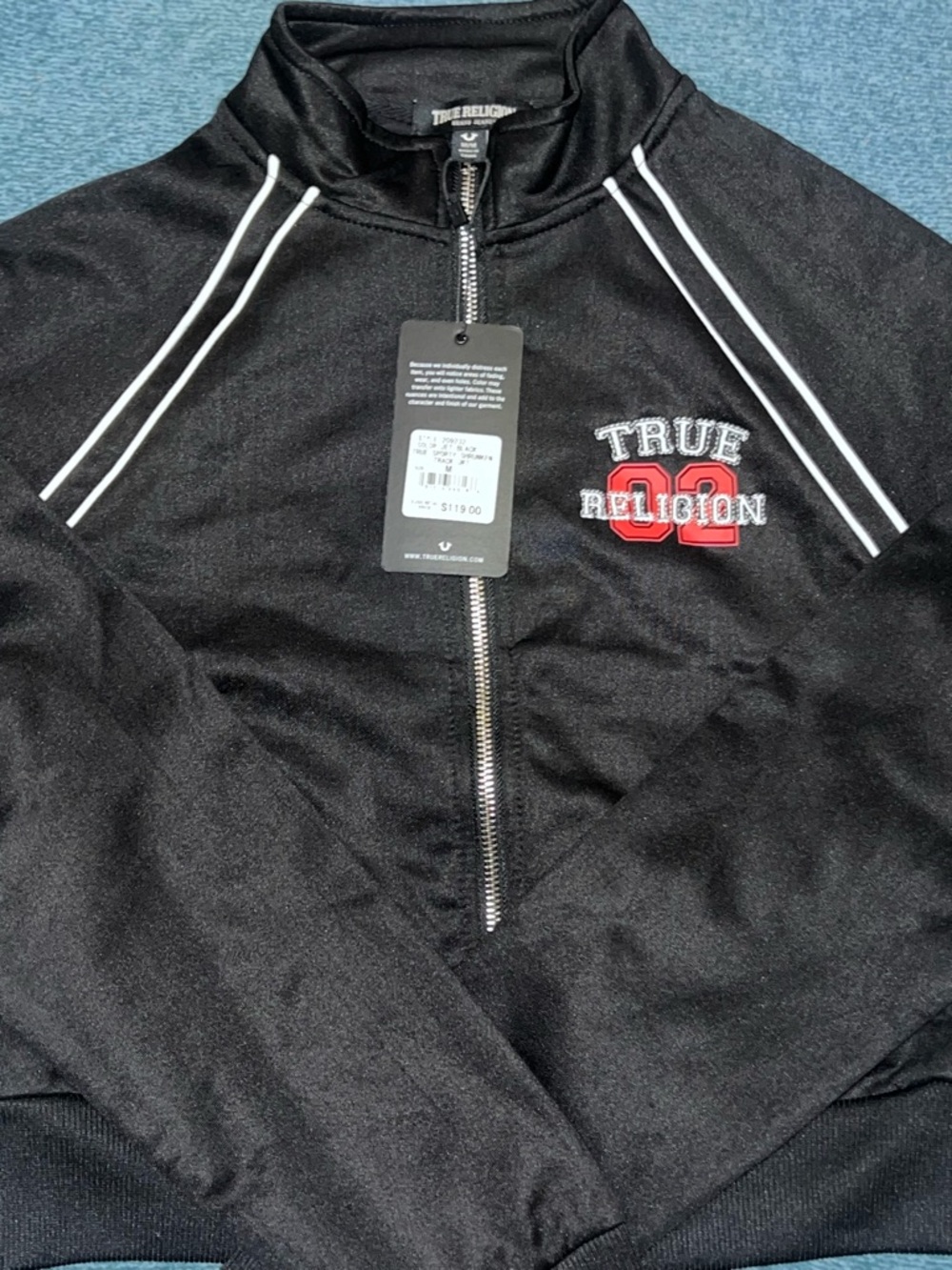 True Religion Teen Black Zip-Up Track Jacket with Red Logo Accents.
